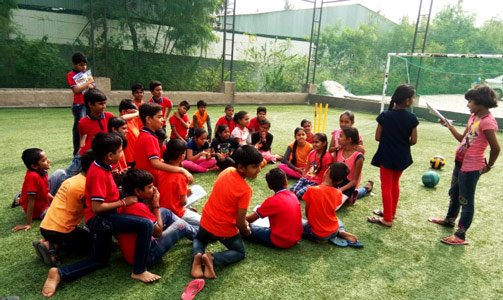 kranthi-keen-coaching-students-in-playground.jpg